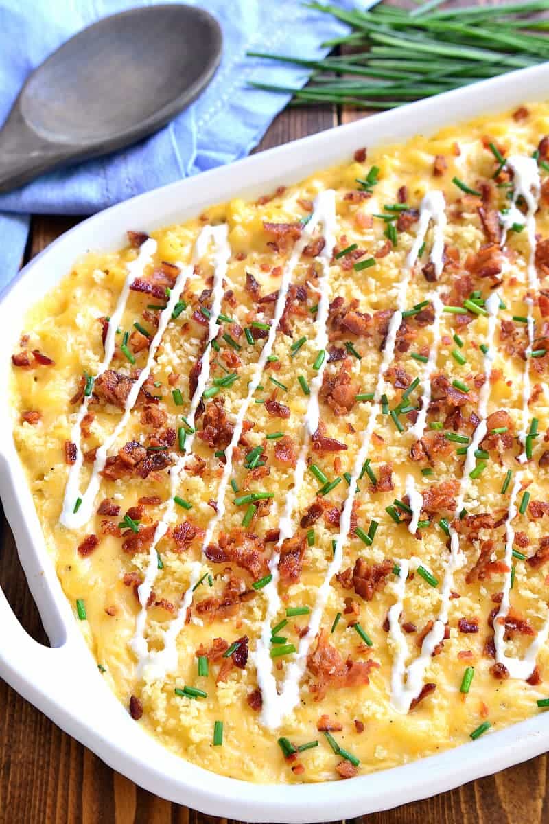 Deliciously creamy Baked Mac & Cheese, loaded with sour cream, bacon, and chives and topped with buttery bread crumbs. The BEST mac & cheese ever....sure to become a family favorite!