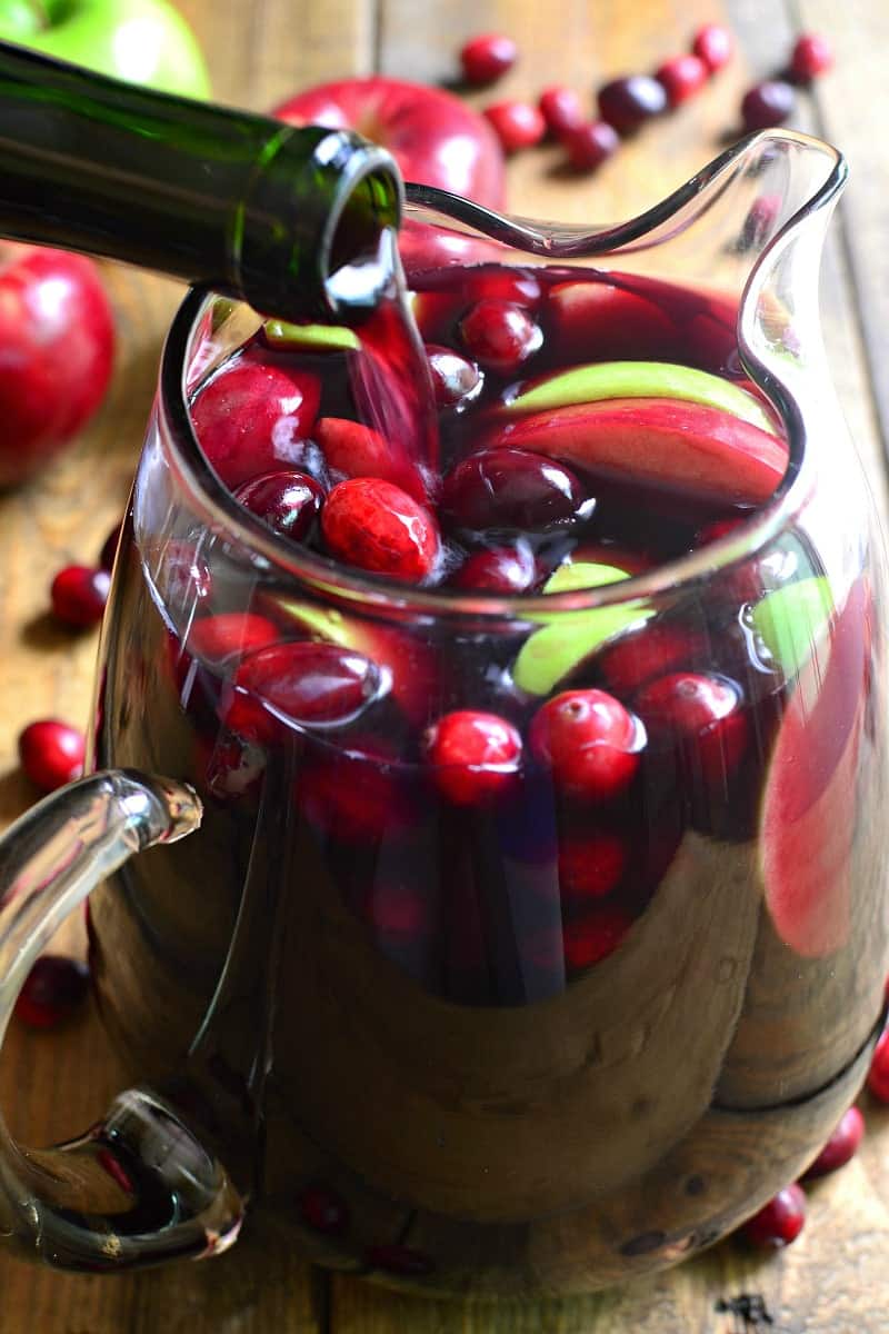 Wine pouring into pitcher of sangria