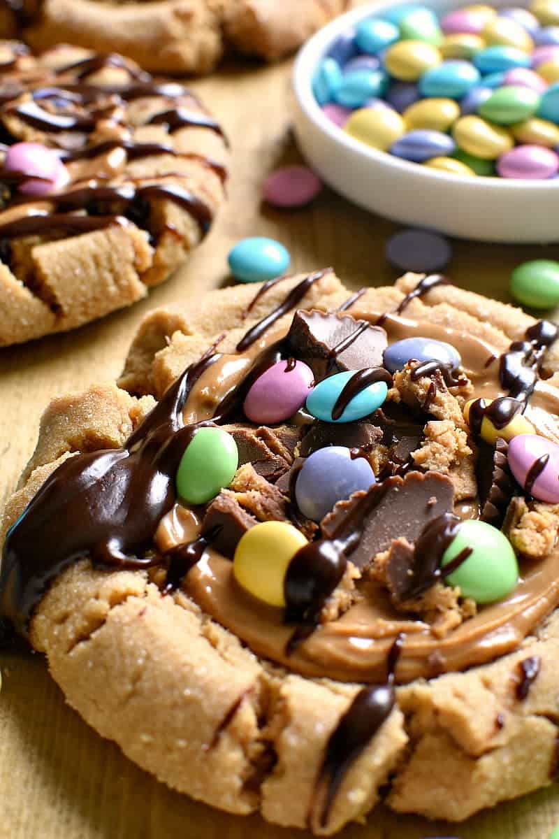 These Chocolate Peanut Butter Overload Cookies are a peanut butter lover's dream! Topped with peanut butter cups, M&M's, and chocolate ganache....they're the ultimate chocolate peanut butter combo!