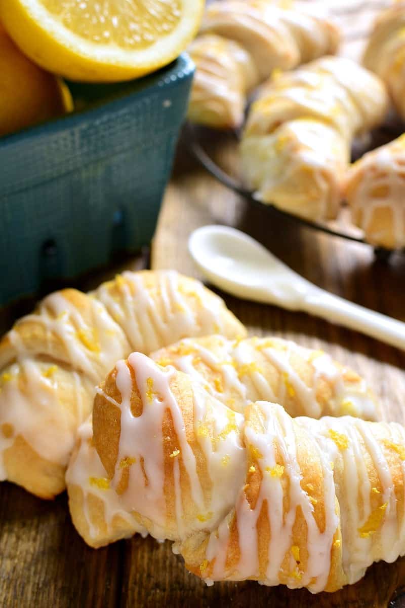 These Lemon Cheesecake Crescent Rolls are bursting with bright lemon flavor! Flaky crescent rolls filled with creamy lemon cheesecake and topped with a citrus glaze....they're the perfect addition to any brunch!