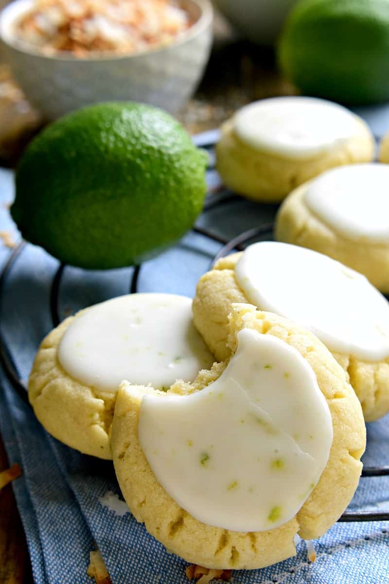 These Coconut Lime Sugar Cookies are a delicious taste of the tropics! Soft, pillowy sugar cookies flavored with coconut and lime zest, then topped with a sweet lime icing. Sure to become a new favorite!