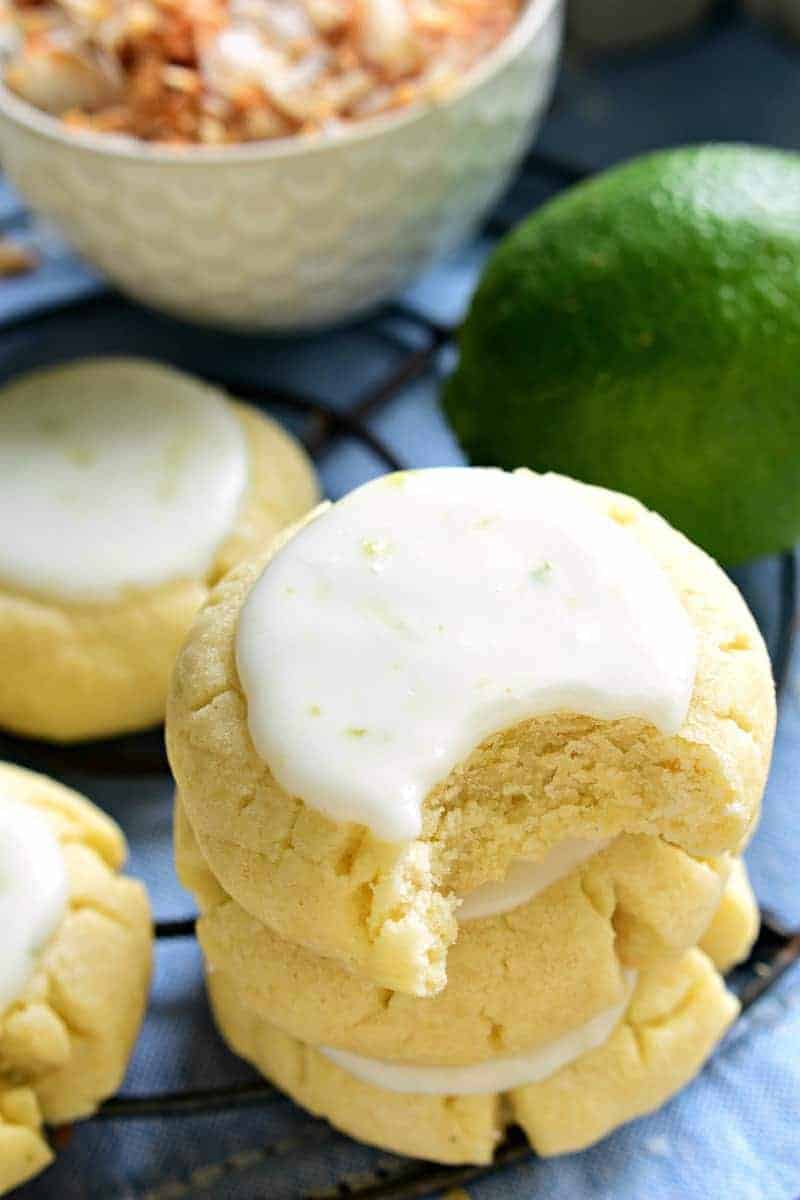 These Coconut Lime Sugar Cookies are a delicious taste of the tropics! Soft, pillowy sugar cookies flavored with coconut and lime zest, then topped with a sweet lime icing. Sure to become a new favorite!