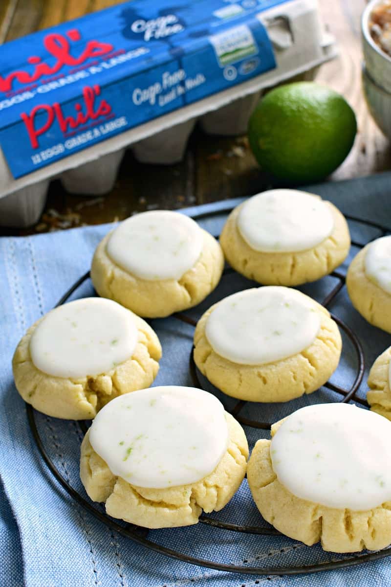 These Coconut Lime Sugar Cookies are a delicious taste of the tropics! Soft, pillowy sugar cookies flavored with coconut and lime zest, then topped with a sweet lime icing. Sure to become a new favorite!