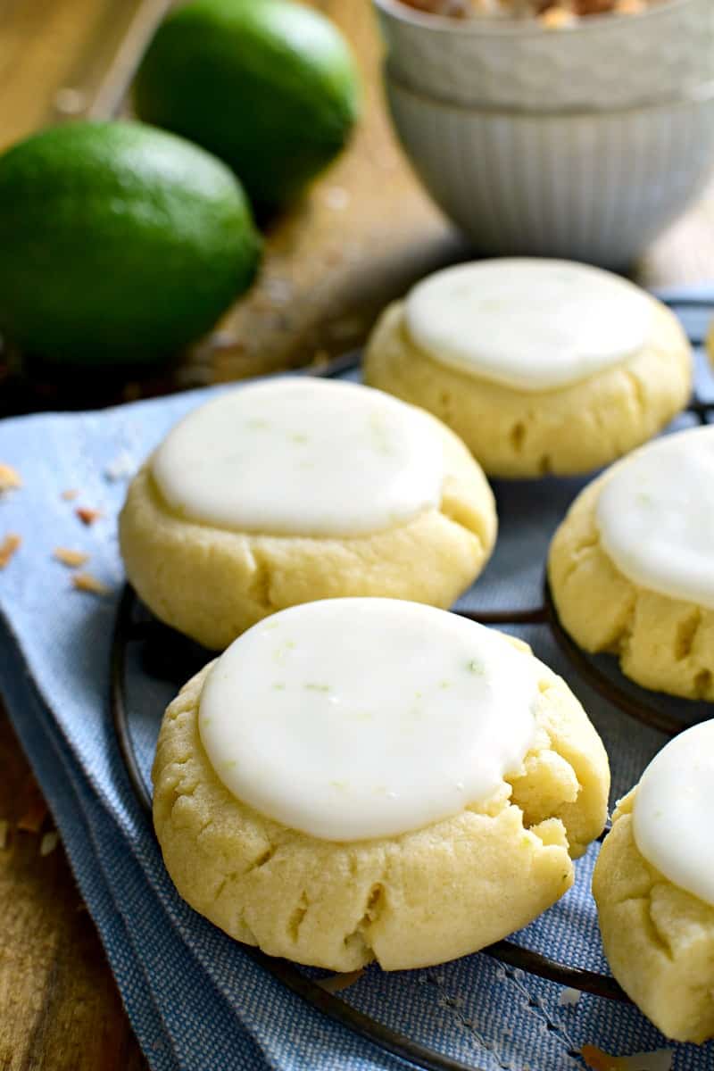 These Coconut Lime Sugar Cookies are a delicious taste of the tropics! Soft, pillowy sugar cookies flavored with coconut and lime zest, then topped with a sweet lime icing. Sure to become a new favorite!