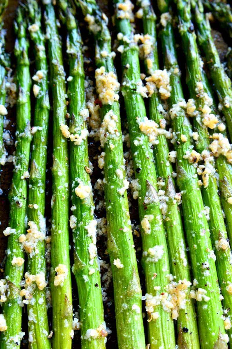 This Garlic Roasted Asparagus is packed with the delicious flavors of garlic and parmesan and is ready in 15 minutes or less! The perfect side dish for any meal....if you love garlic, this Garlic Roasted Asparagus is sure to become a favorite!