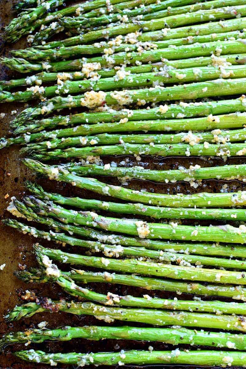 This Garlic Roasted Asparagus is packed with the delicious flavors of garlic and parmesan and is ready in 15 minutes or less! The perfect side dish for any meal....if you love garlic, this Garlic Roasted Asparagus is sure to become a favorite!