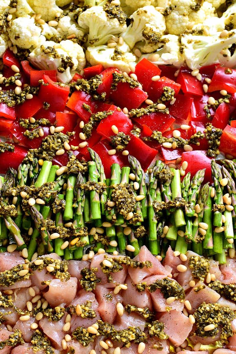 This Sheet Pan Pesto Chicken is loaded with veggies and packed with delicious flavor! Best of all, it requires just 10 minutes of prep and 20 minutes in the oven....all on just one pan!