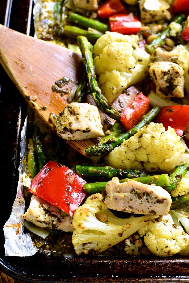 This Sheet Pan Pesto Chicken is loaded with veggies and packed with delicious flavor! Best of all, it requires just 10 minutes of prep and 20 minutes in the oven....all on just one pan!