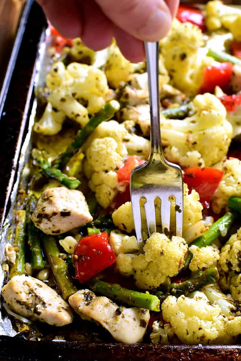 This Sheet Pan Pesto Chicken is loaded with veggies and packed with delicious flavor! Best of all, it requires just 10 minutes of prep and 20 minutes in the oven....all on just one pan!