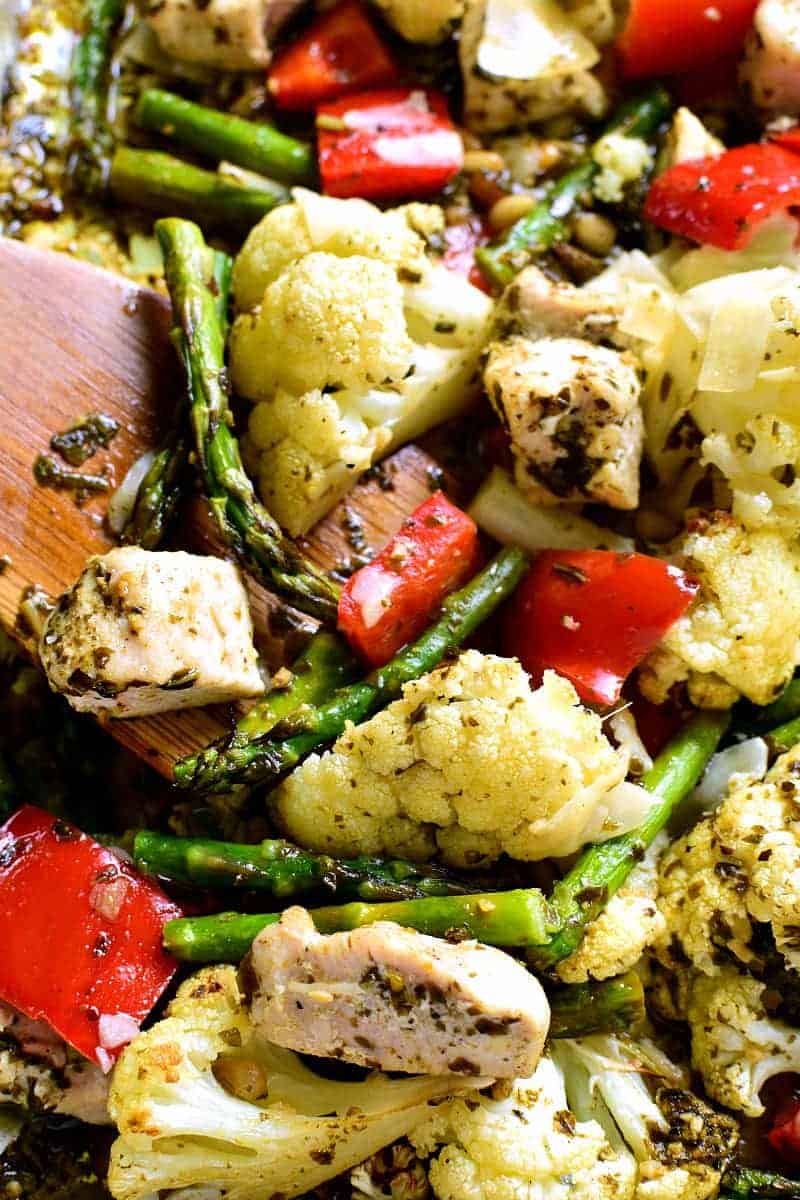 This Sheet Pan Pesto Chicken is loaded with veggies and packed with delicious flavor! Best of all, it requires just 10 minutes of prep and 20 minutes in the oven....all on just one pan!