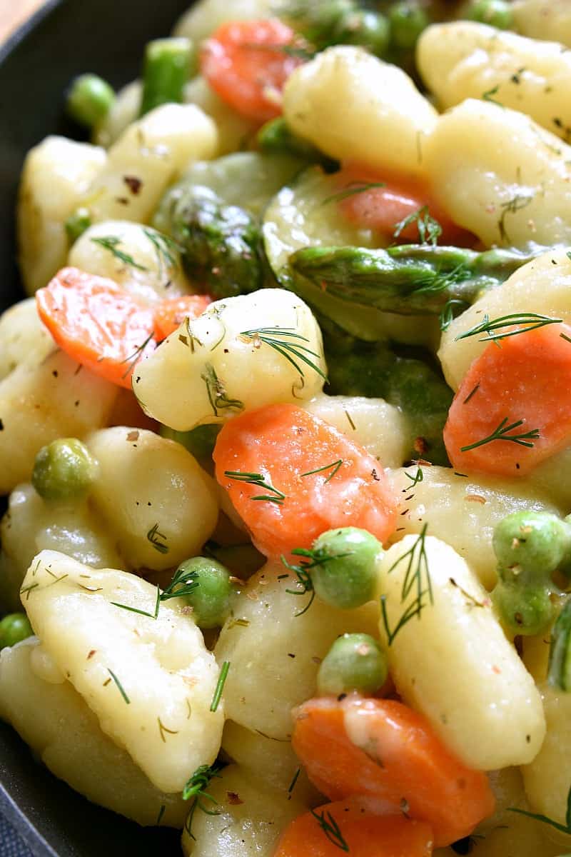 This Spring Vegetable Gnocchi is creamy, delicious, and comfort food at its finest. This gnocchi is loaded with fresh vegetables and comes together in under 20 minutes.