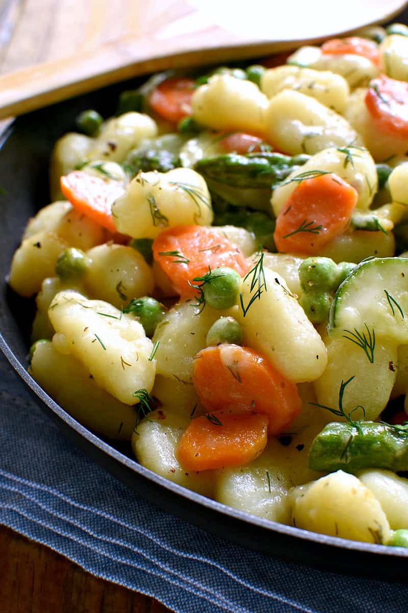 This Spring Vegetable Gnocchi is creamy, delicious, and comfort food at its finest. This gnocchi is loaded with fresh vegetables and comes together in under 20 minutes. 