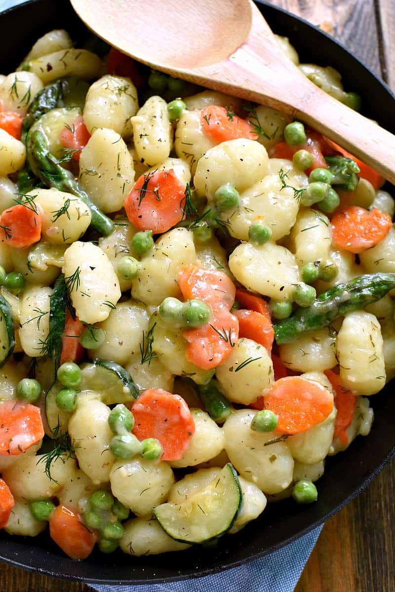 This Spring Vegetable Gnocchi is creamy, delicious, and comfort food at its finest. This gnocchi is loaded with fresh vegetables and comes together in under 20 minutes.