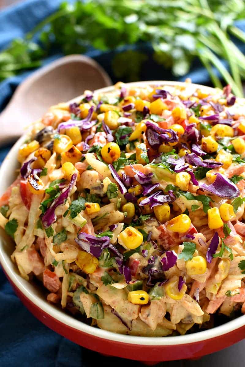 Taco Salad meets coleslaw in this deliciously creamy Mexican Coleslaw! Packed with flavor and perfect for summer cookouts!