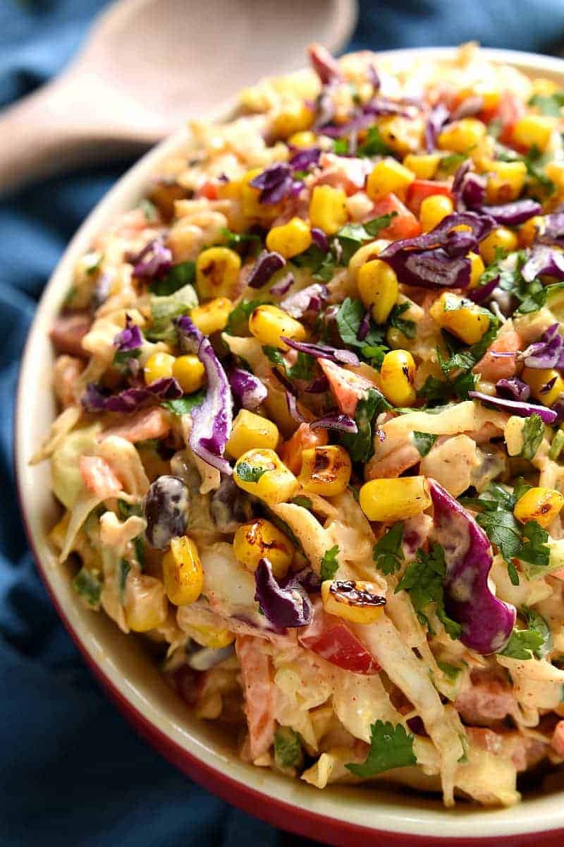 Taco Salad meets coleslaw in this deliciously creamy Mexican Coleslaw! Packed with flavor and perfect for summer cookouts!