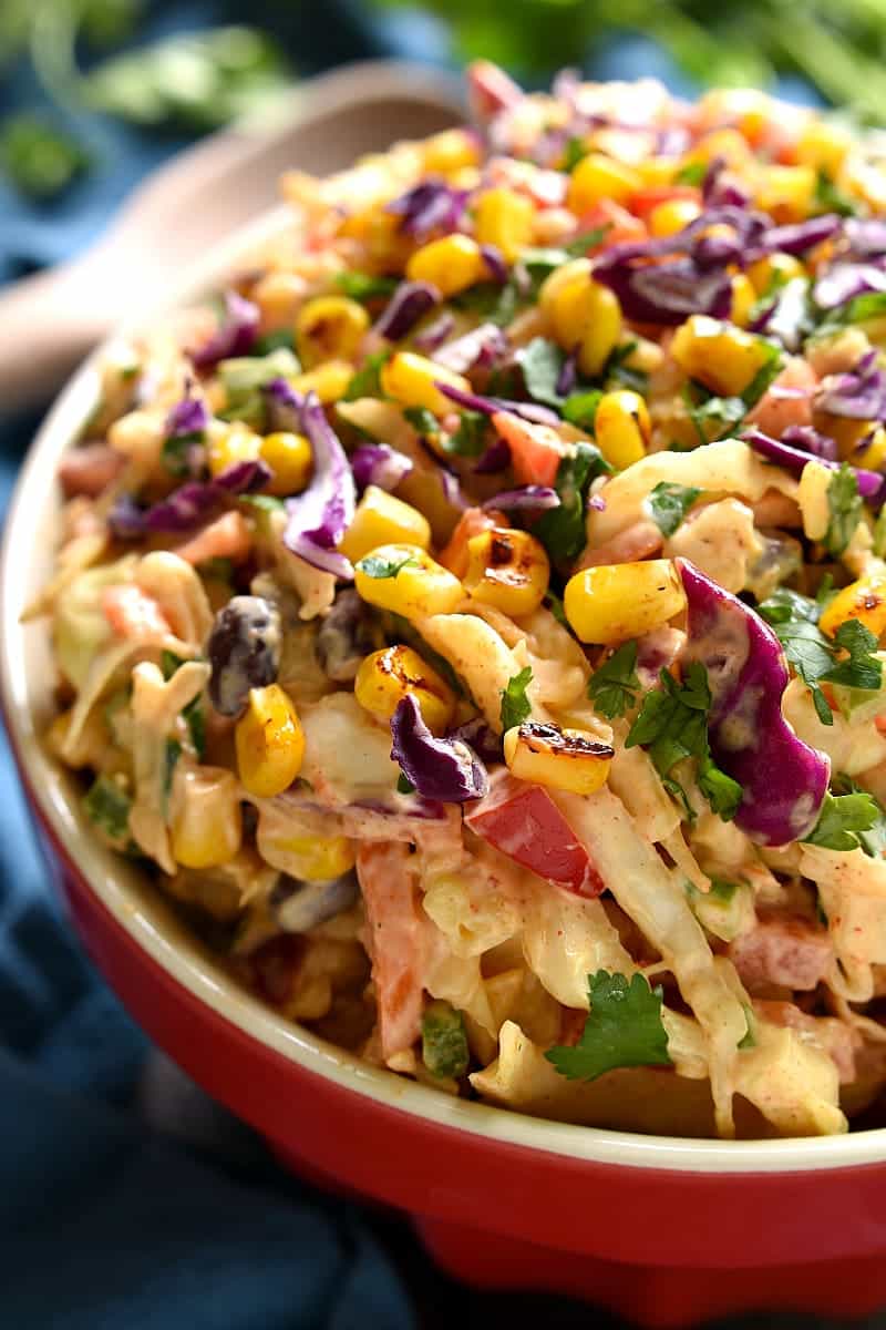 Taco Salad meets coleslaw in this deliciously creamy Mexican Coleslaw! Packed with flavor and perfect for summer cookouts!