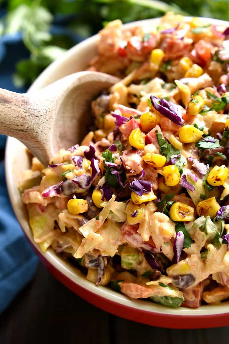 Taco Salad meets coleslaw in this deliciously creamy Mexican Coleslaw! Packed with flavor and perfect for summer cookouts!