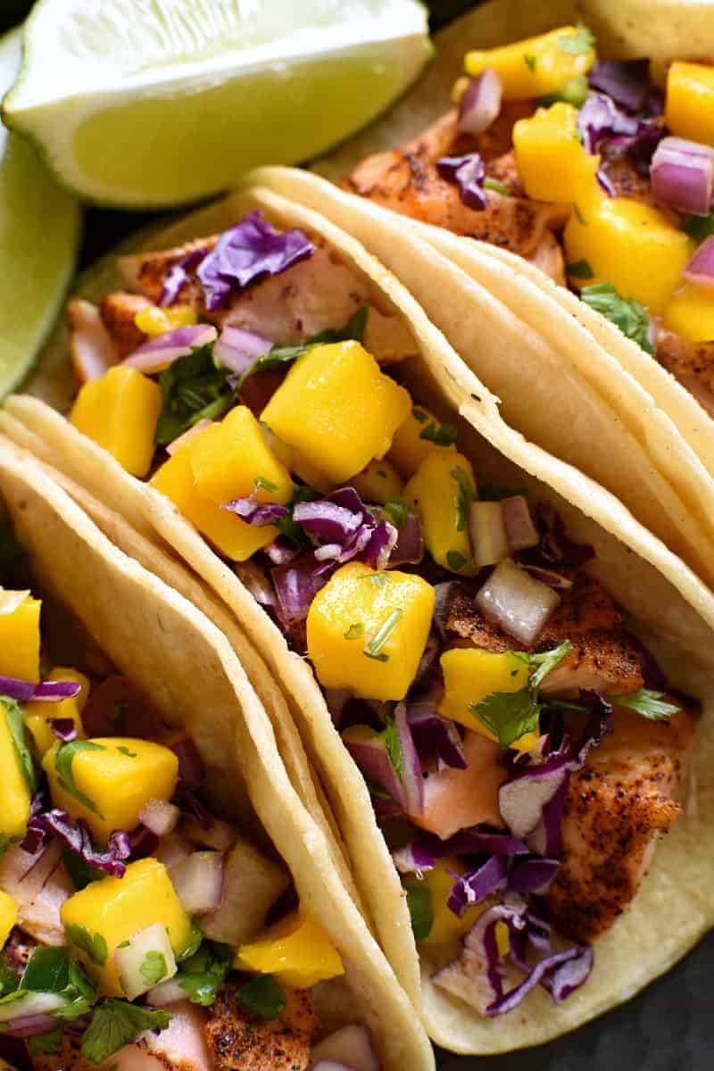 overhead image of a fish taco made with salmon topped with mango salsa