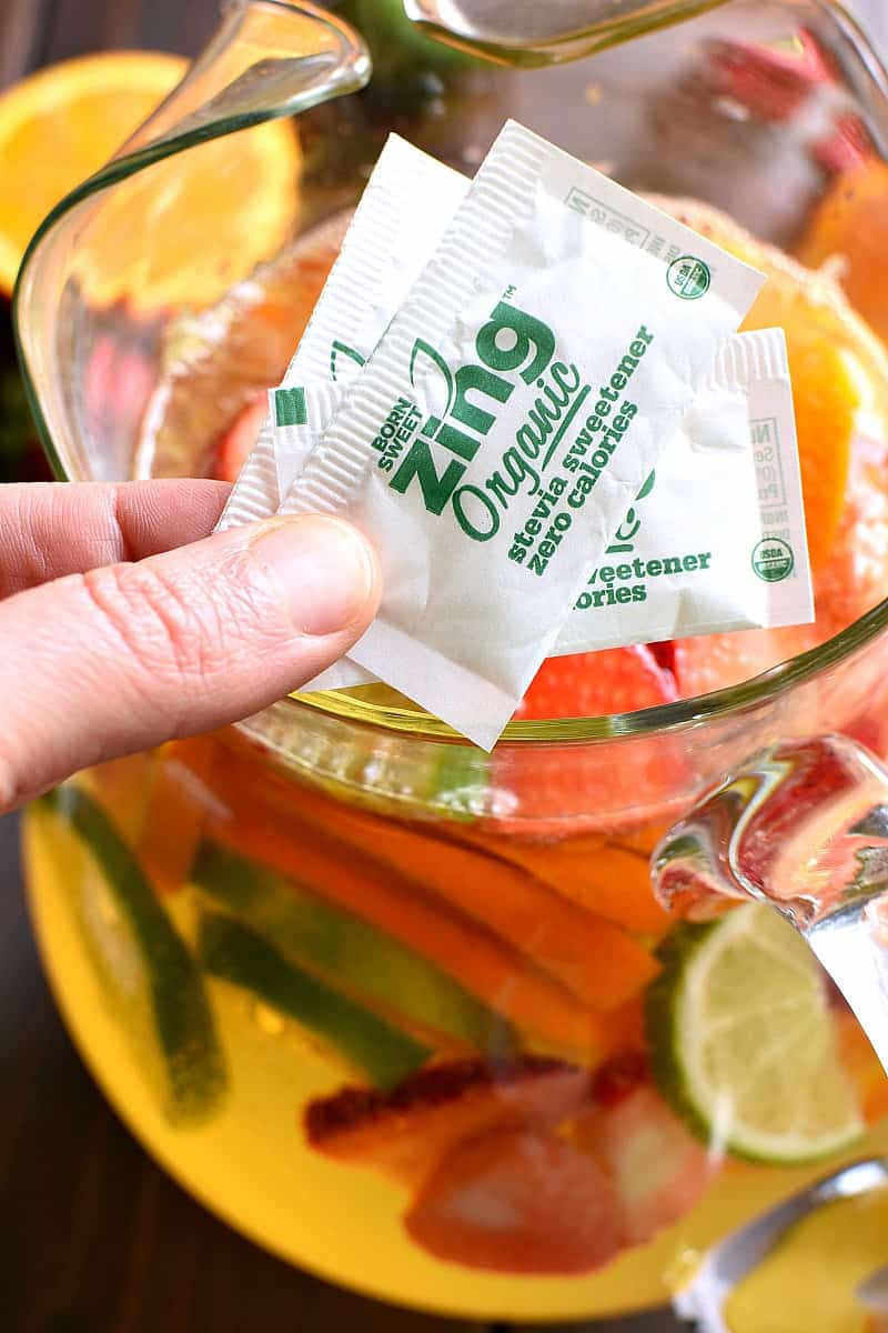 packets of Zing organic stevia being added to a pitcher of sparkling sangria