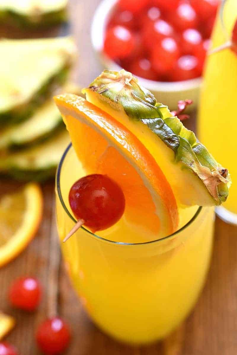 tropical mimosas garnished with fresh fruit