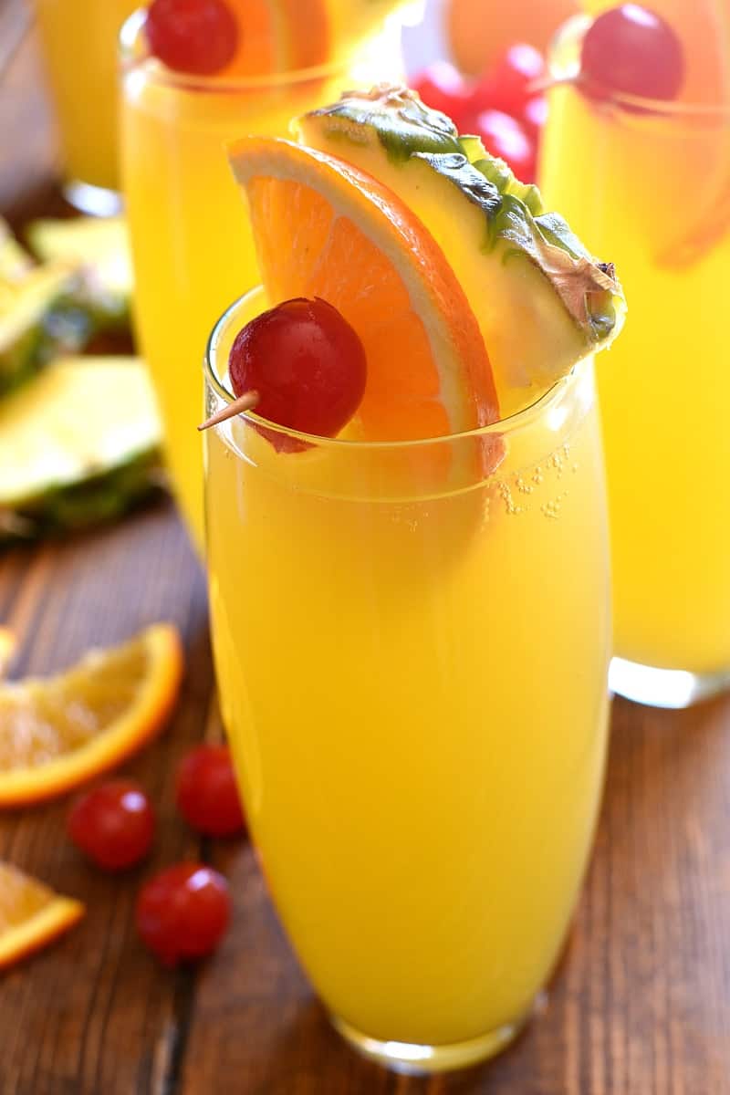 tall glasses filled with Tropical Mimosas