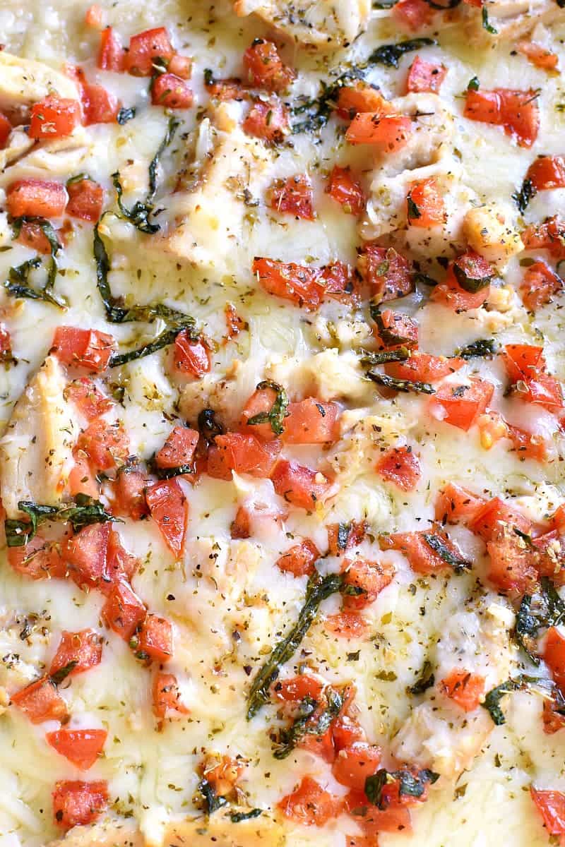 This Bruschetta Chicken Alfredo Pizza is a little taste of Italy, right in your own kitchen! Packed with delicious flavor and ready in under 30 minutes, this pizza is perfect for family night, date night, or a fun night with friends!