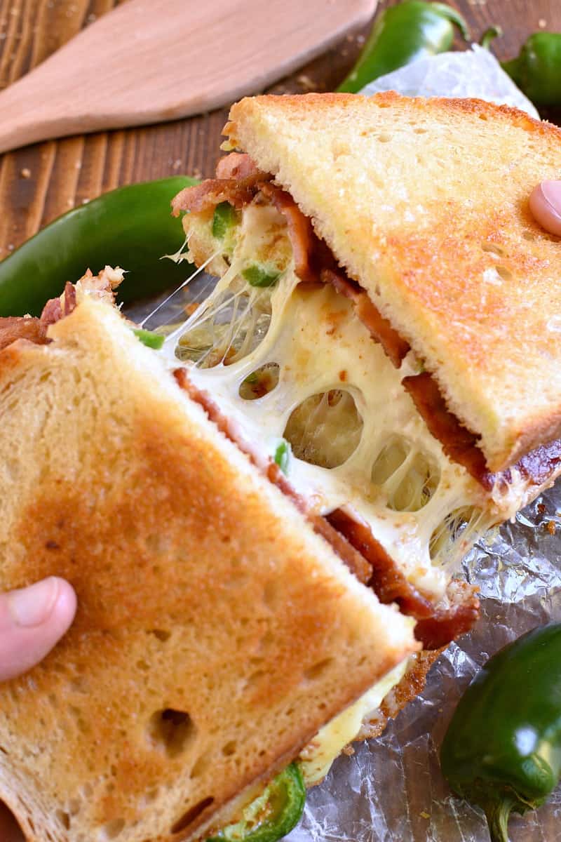 This Jalapeño Popper Grilled Cheese is EVERYTHING!! Gooey, spicy, cheesy, and SO delicious. If you love jalapeño poppers you'll go crazy for this awesome sandwich!