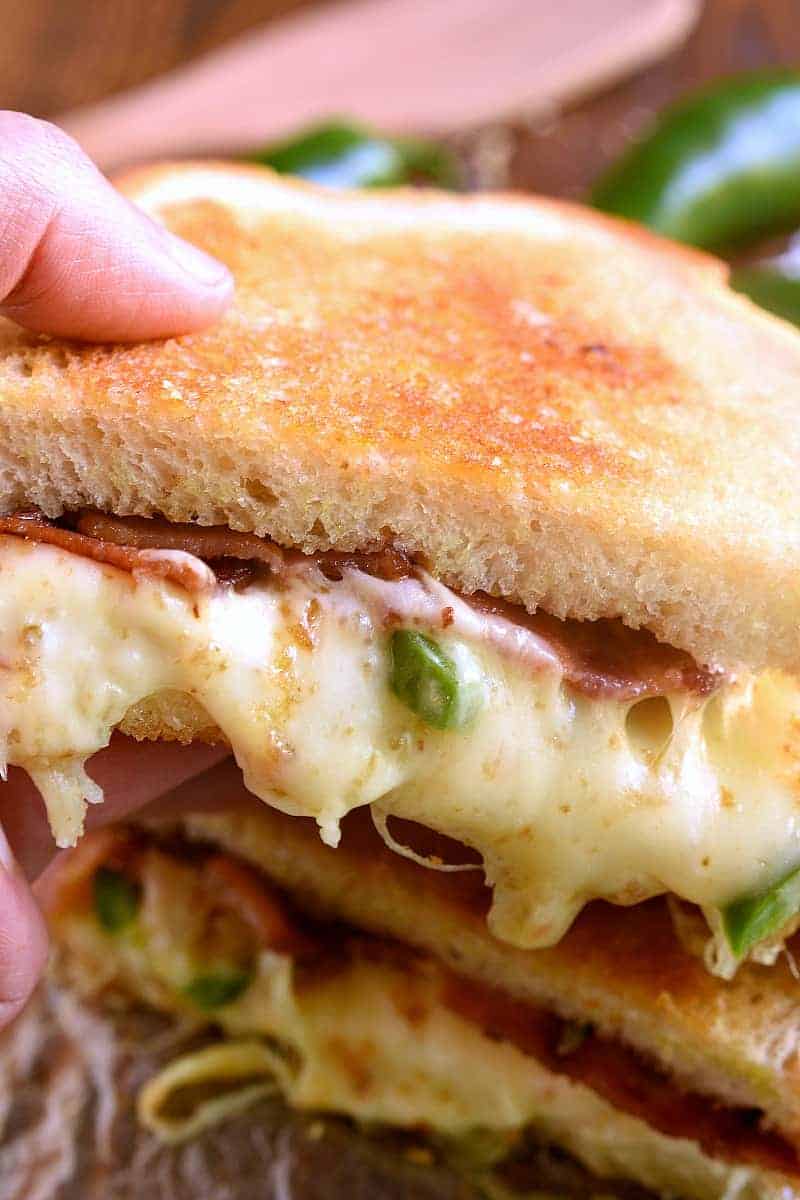 This Jalapeño Popper Grilled Cheese is EVERYTHING!! Gooey, spicy, cheesy, and SO delicious. If you love jalapeño poppers you'll go crazy for this awesome sandwich!