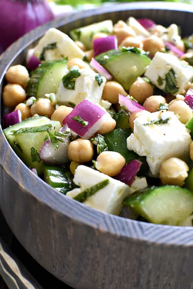 This Chickpea Cucumber Feta Salad has ALL the best flavors! Loaded with chickpeas, cucumbers, red onions, feta cheese, and fresh basil....this salad is so easy to make and is the perfect side dish for any meal!