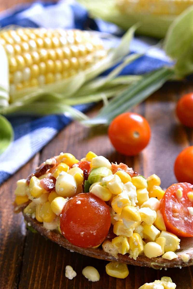 This Bacon Blue Cheese Corn Salad is the most delicious corn salad ever! Fresh sweet corn combined with crispy bacon, cherry tomatoes, crumbled blue cheese, green onions, and a light vinaigrette. Perfect for summer picnics, cookouts, or pot lucks!