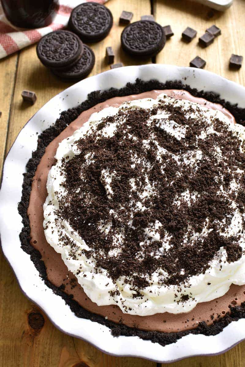This Frozen Death by Chocolate Pie is the ULTIMATE chocolate lover's treat! Loaded with delicious chocolate flavor and topped with homemade whipped cream and hot fudge, this pie is perfect for birthdays, ladies nights, or special occasions. And best of all, it's completely no-bake!