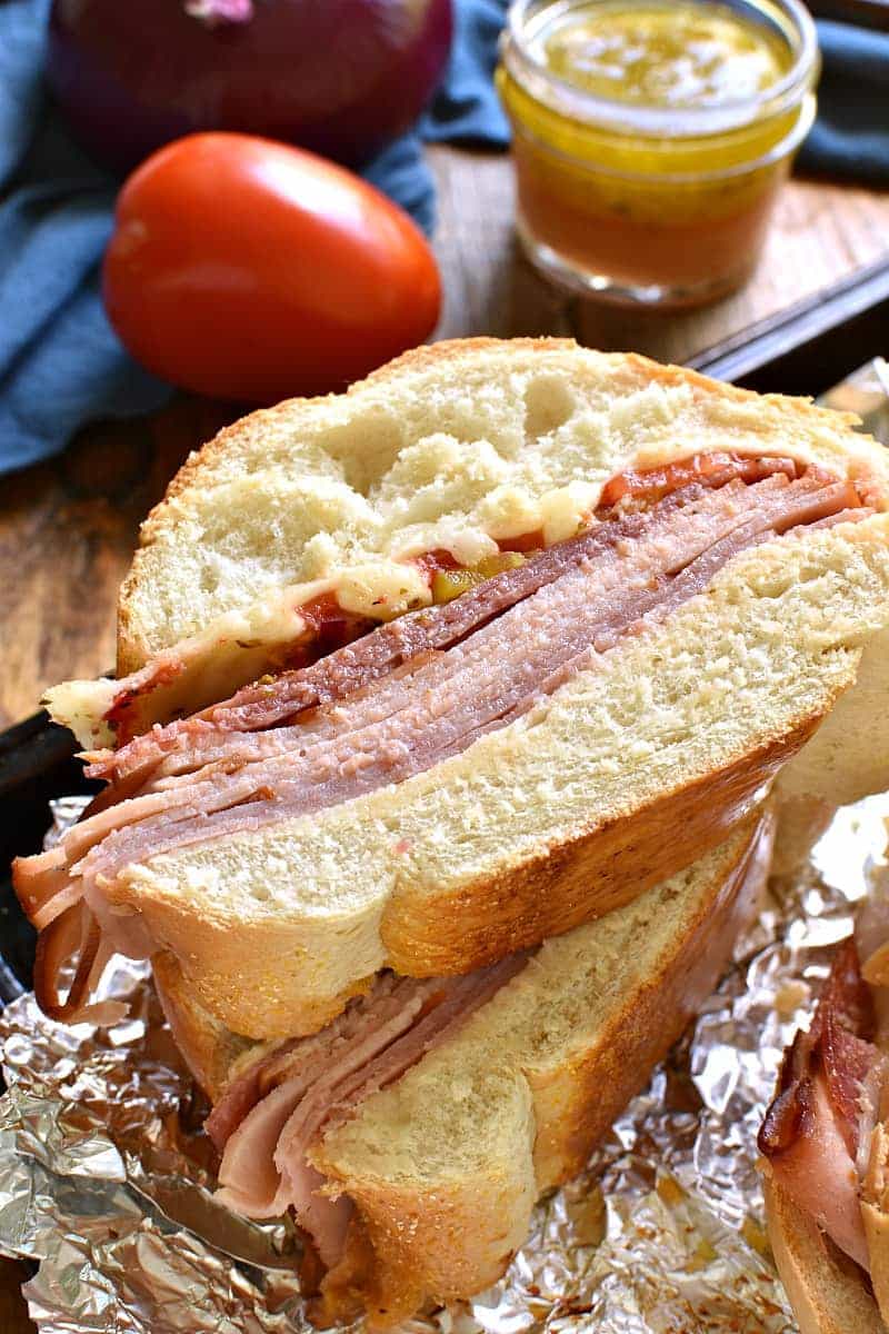 This Baked Italian Party Sub is perfect for feeding a crowd! Loaded with the delicious flavors of salami, turkey, ham, provolone, tomatoes, peppers, red onions, and homemade Italian vinaigrette, this sandwich is party-ready whenever you are....and guaranteed to make all your guests very happy!