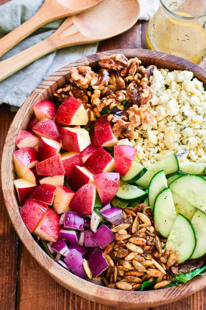 This Apple Walnut Salad is the ultimate salad for fall! Loaded with fresh apples, crisp cucumber, crunchy walnuts, toasted pumpkin seeds, gorgonzola cheese, and sweet honey poppy seed dressing....this salad is the perfect balance of savory, sweet, crunchy, and SO delicious. 