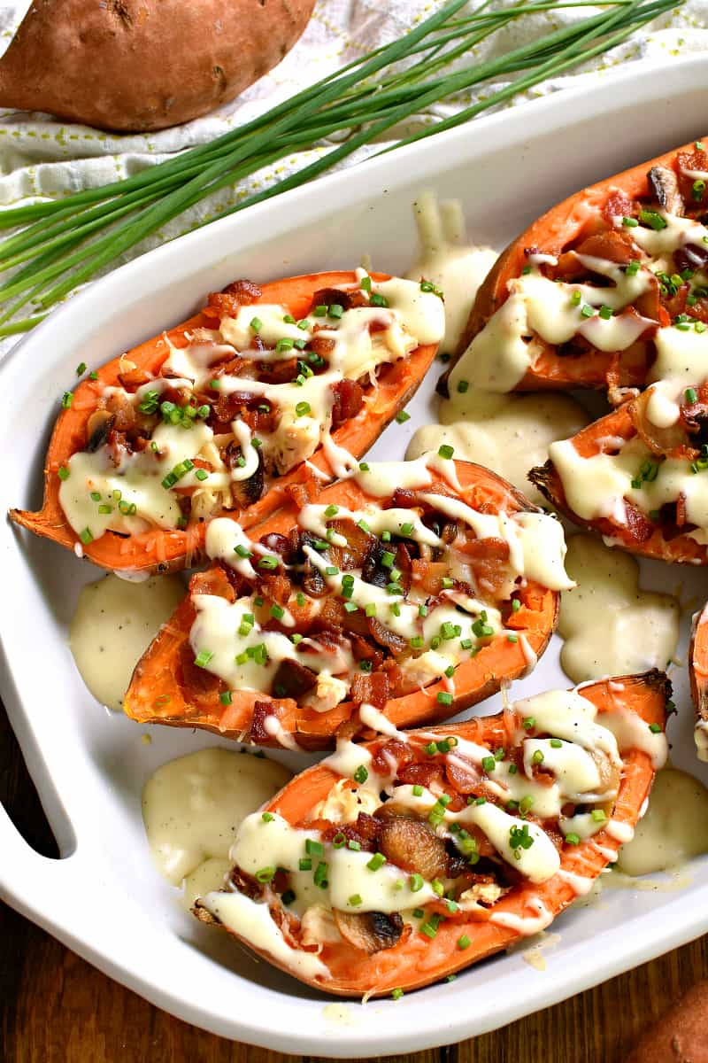 These Loaded Baked Sweet Potatoes make the most delicious dinner! Stuffed with chicken, bacon, mushrooms, swiss cheese, and a creamy cheese sauce, they're easy to make and packed with flavor! Sure to become a new family favorite!