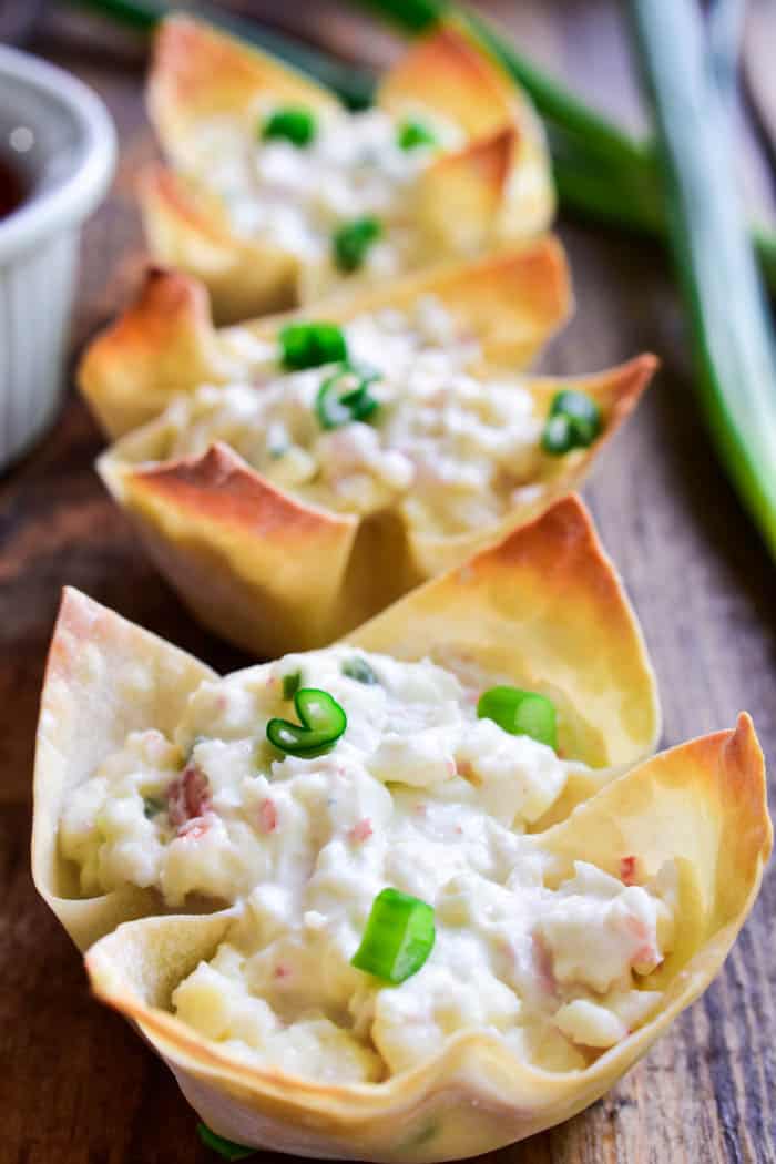If you love crab rangoon, you'll LOVE these baked Crab Rangoon Wonton Cups! They have all the flavors of your favorite Chinese appetizer in a baked wonton cup, which means they're not only better for you, but they're so much easier to make. Ready in 30 minutes or less, these bite sized wontons are the perfect appetizer for all your holiday parties....and guaranteed to be a HUGE hit. Serve them straight out of the oven or dip them in your favorite sweet & sour sauce. Any way you enjoy them, there's no question that this recipe is sure to become a favorite!