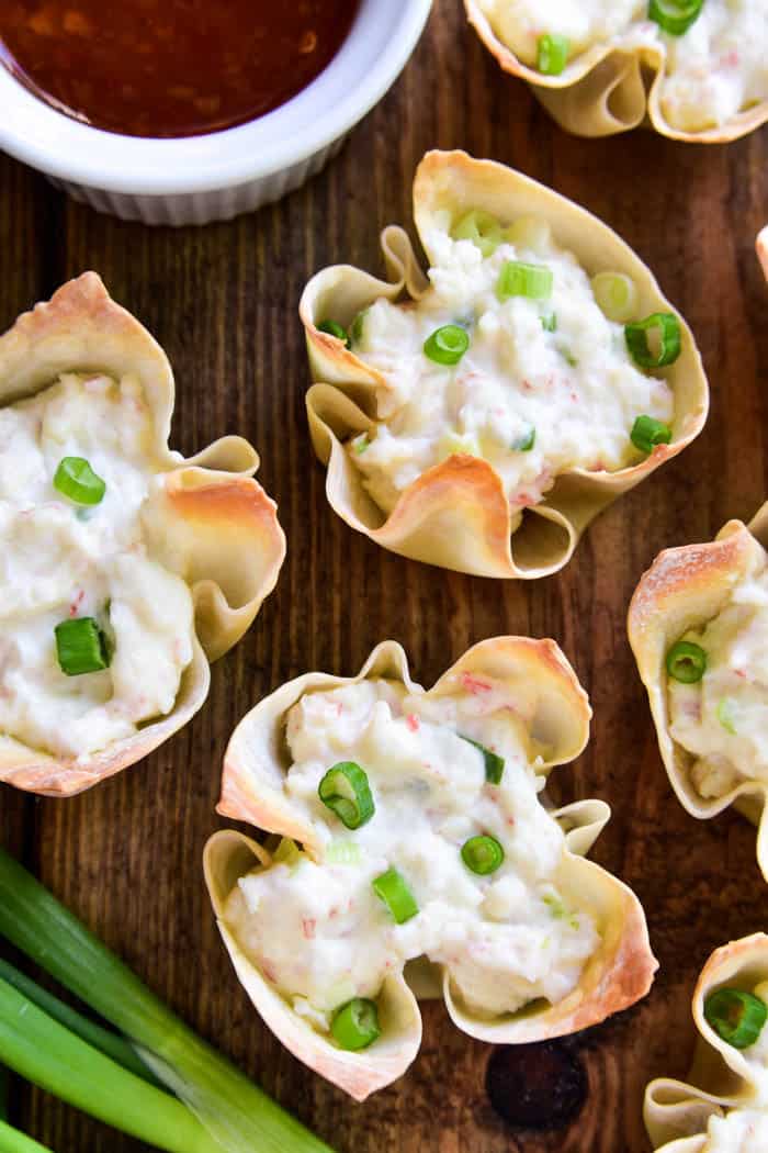 If you love crab rangoon, you'll LOVE these baked Crab Rangoon Wonton Cups! They have all the flavors of your favorite Chinese appetizer in a baked wonton cup, which means they're not only better for you, but they're so much easier to make. Ready in 30 minutes or less, these bite sized wontons are the perfect appetizer for all your holiday parties....and guaranteed to be a HUGE hit. Serve them straight out of the oven or dip them in your favorite sweet & sour sauce. Any way you enjoy them, there's no question that this recipe is sure to become a favorite!