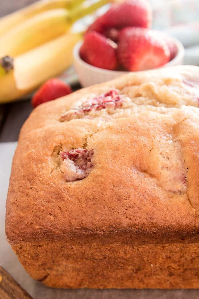 Banana Bread gets a fun new twist with the addition of fresh strawberries! This Strawberry Banana Bread starts with the BEST Banana Bread recipe and adds just a few simple ingredients to take it to the next level. Perfect for breakfast, snack, or even dessert...this recipe is packed with delicious flavor and sure to become a new favorite. If your family loves fresh, homemade bread, they'll go crazy for this delicious Strawberry Banana Bread! And you'll love how easy it is to make!
