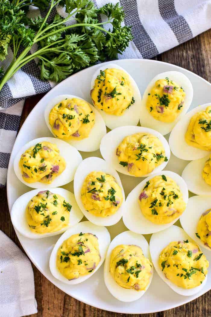 Ham and Cheese Deviled Eggs are a delicious twist on a classic recipe! This easy appetizer is made with just a handful of ingredients, comes together quickly, and is always hit at parties and gatherings. Perfect for Easter brunch, baby showers, or summer cookouts, if you love deviled eggs you'll LOVE this ham and cheese twist!