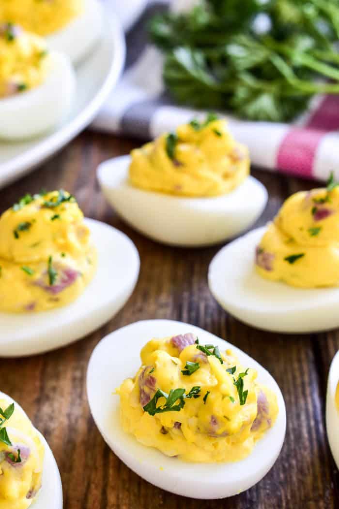 Ham and Cheese Deviled Eggs are a delicious twist on a classic recipe! This easy appetizer is made with just a handful of ingredients, comes together quickly, and is always hit at parties and gatherings. Perfect for Easter brunch, baby showers, or summer cookouts, if you love deviled eggs you'll LOVE this ham and cheese twist!