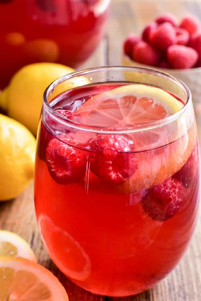 Lemon Raspberry Sangria is the perfect way to welcome in spring! This fruity sangria starts with rose wine and raspberry lemonade and is packed full of fresh raspberries and lemon slices. Ideal for Mother's Day, ladies' nights, or sunny days by the pool. If you love sangria, you'll love this refreshing twist!