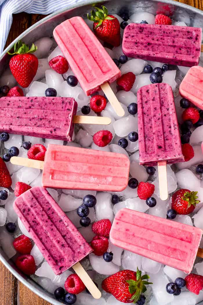 Fruit Smoothie Popsicles are one of our favorite summer treats! They combine all the flavors of a fruit smoothie with all the fun a popsicle. Made with just three simple ingredients, these fruit smoothie popsicles come together in minutes and make a delicious breakfast, snack, or after dinner treat. They can be made with any combination of fruit, which means theres a flavor combination for everyone! Whether you're a smoothie lover or looking to eat healthier this summer, these Fruit Smoothie Popsicles are destined to become a new summer (or year round) favorite!