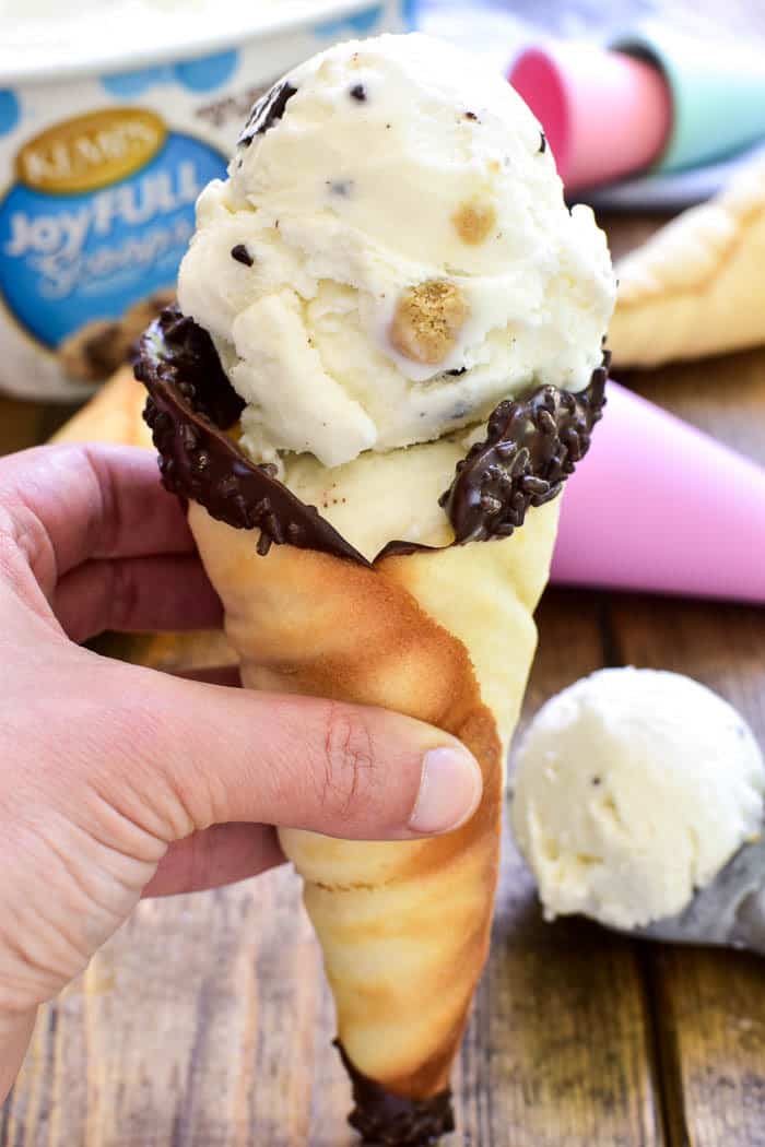 Take your favorite summer treat to the next level with Homemade Sugar Cones! These cones are easy to make, with just a handful of ingredients, and they taste amazing. Best of all, there's no waffle cone maker required. Which means anyone can make them! These homemade ice cream cones can be made in the oven or on the stovetop, and they can easily be made in different sizes and decorated for different occasions. They're the perfect EASY way to make your favorite frozen treats even better!