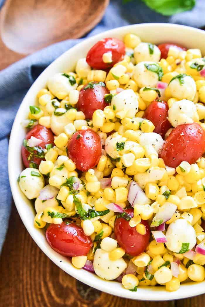 This Caprese Corn Salad combines some of the BEST flavors of summer in one delicious side dish! Fresh sweet corn meets the classic flavor combination of tomatoes, basil, and fresh mozzarella. Dressed in a light vinaigrette, this salad is the perfect side dish for any meal. It can be enjoyed all on its own or topped with grilled chicken or shrimp for a light yet satisfying dish. If you love caprese salad, you'll love this easy, flavorful summer twist!