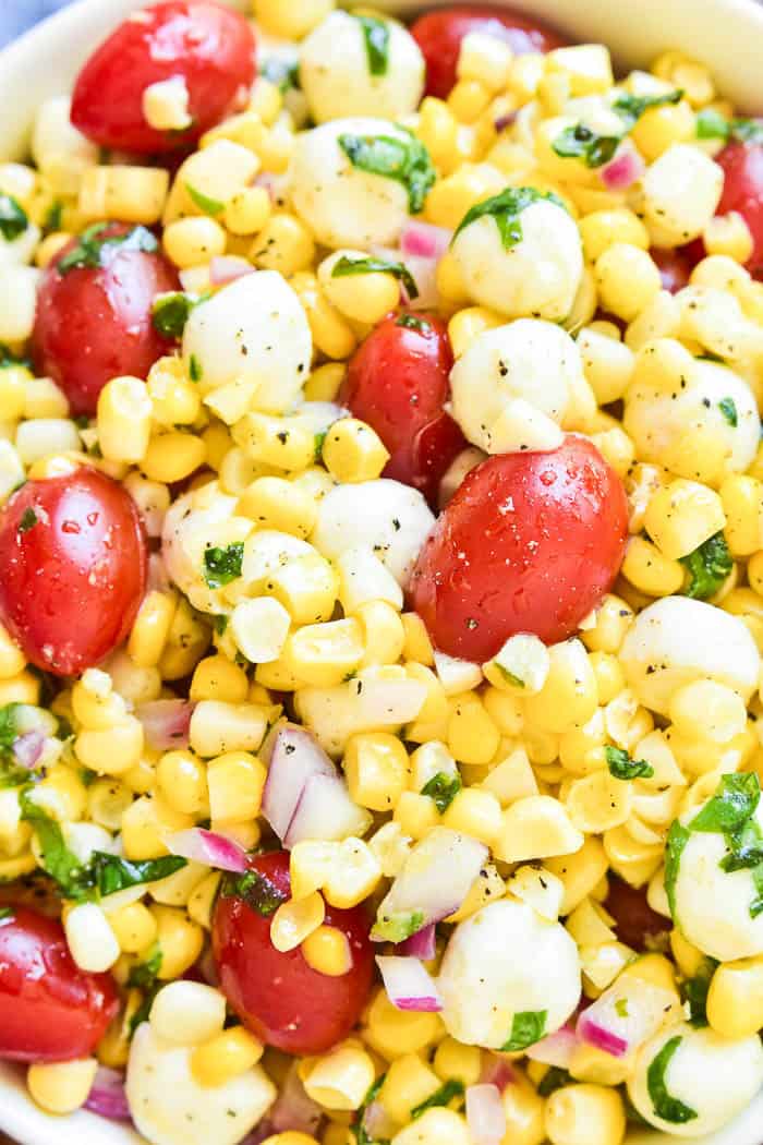 This Caprese Corn Salad combines some of the BEST flavors of summer in one delicious side dish! Fresh sweet corn meets the classic flavor combination of tomatoes, basil, and fresh mozzarella. Dressed in a light vinaigrette, this salad is the perfect side dish for any meal. It can be enjoyed all on its own or topped with grilled chicken or shrimp for a light yet satisfying dish. If you love caprese salad, you'll love this easy, flavorful summer twist!