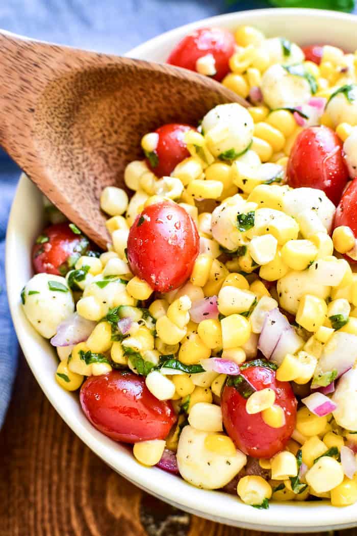 This Caprese Corn Salad combines some of the BEST flavors of summer in one delicious side dish! Fresh sweet corn meets the classic flavor combination of tomatoes, basil, and fresh mozzarella. Dressed in a light vinaigrette, this salad is the perfect side dish for any meal. It can be enjoyed all on its own or topped with grilled chicken or shrimp for a light yet satisfying dish. If you love caprese salad, you'll love this easy, flavorful summer twist!