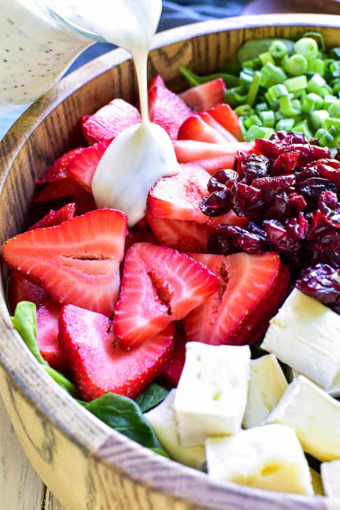This Strawberry Brie Spinach Salad is one of our favorites! Made with fresh spinach, sliced strawberries, dried cranberries, pecans, and brie cheese, this salad is the perfect combination of savory, sweet, creamy, and delicious. It makes a great lunchtime salad and can be topped with chicken or shrimp for a more satisfying dinner. And....it's equally delicious as a fresh, unique side dish for any meal.