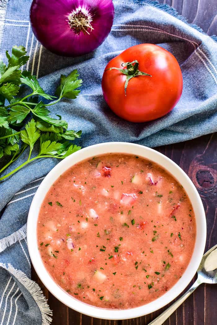 This Easy Gazpacho is the perfect way to make use of fresh garden veggies! Loaded with ripe tomatoes, cucumbers, red peppers, and onions, this chilled soup has just the right blend of flavors and textures. It makes a delicious lunch or dinner, and could also be served a light appetizer. 