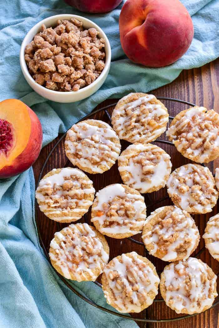 These Peach Cobbler Cookie Cups are the most delicious little bites! Made with a sugar cookie base and topped with peach pie filling and streusel topping, these cookies cups are easy to make and so tasty. Perfect for end of summer parties, lunchbox treats, or your last minute barbecue....if you love peach cobbler you'll go crazy for this bite sized alternative!