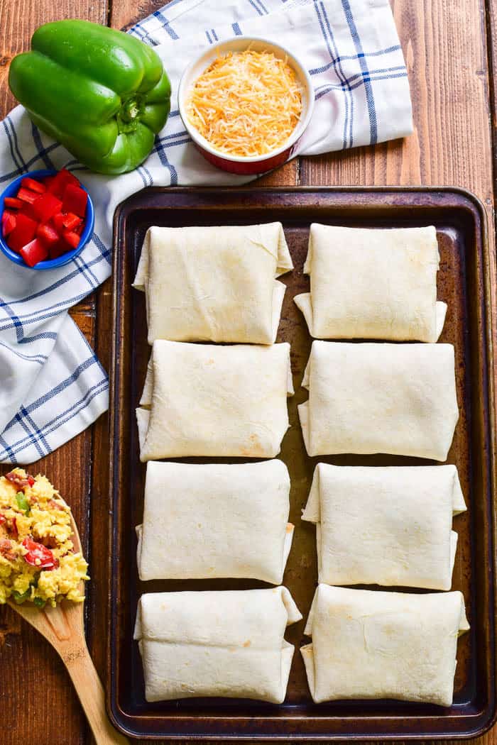 These Southwest Breakfast Burritos are packed with the BEST flavors! Loaded with scrambled eggs, bacon, peppers, cheese, and a creamy chipotle sauce, they’re a deliciously satisfying way to start the day. These burritos are easy to make ahead and store in the fridge or freezer, then re-heat in the microwave for a quick and easy breakfast. They're perfect for adults and kids, alike....and guaranteed to take the stress out of busy mornings!