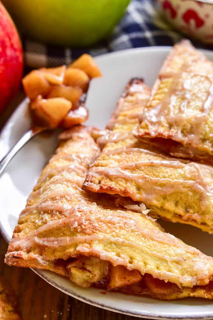 Apple Pie meets Baked Brie in these delicious Apple Brie Turnovers. Stuffed with homemade apple pie filling and creamy brie cheese, they're the perfect combination of savory and sweet. These turnovers make a delicious breakfast, snack, or dessert, and they're fun to eat & easy to make. If you love apple turnovers you'll love this unique, savory twist!